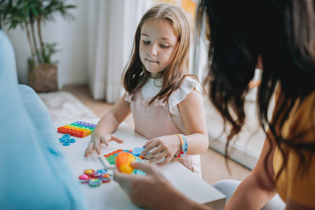 istock mother playing with autistic daughter 2030019943