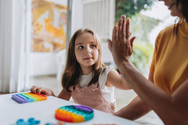 istock mother playing with autistic daughter 2030019953