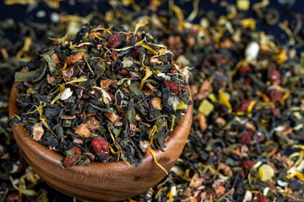 dry green tea with jasmine flowers, calendula, pineapple slices - tea jasmine tea green black foto e immagini stock