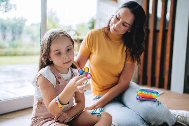 istock mother playing with autistic daughter 2030021562