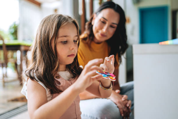 istock mother playing with autistic daughter 2030021563