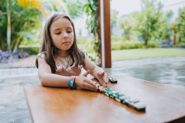 Autistic child playing with cars