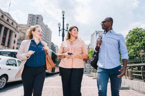 istock Coworkers talking while walking in the street 2030035304