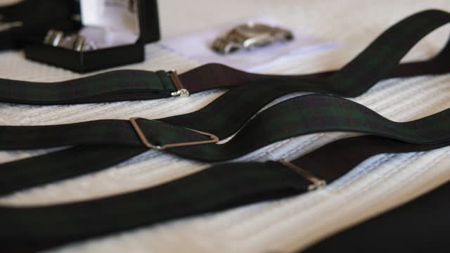 Elegant suspenders on textured fabric backdrop