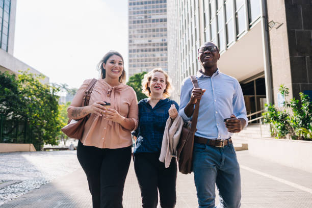 istock Coworkers talking while walking in the street 2030036383