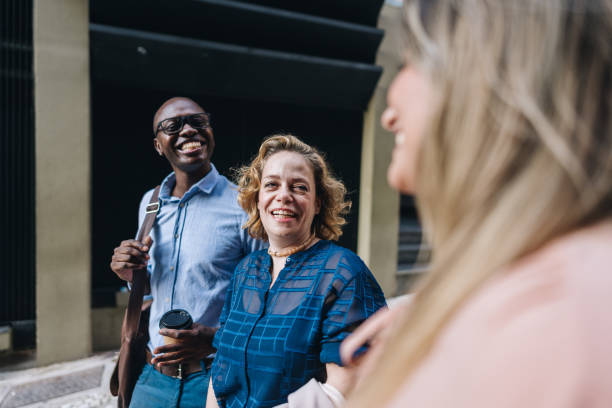 istock Coworkers talking while walking in the street 2030036449