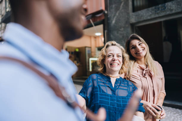 istock Coworkers talking while walking in the street 2030036456