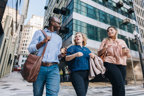 istock Coworkers talking while walking in the street 2030036465