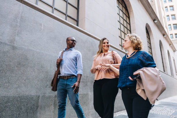 istock Coworkers talking while walking in the street 2030037584