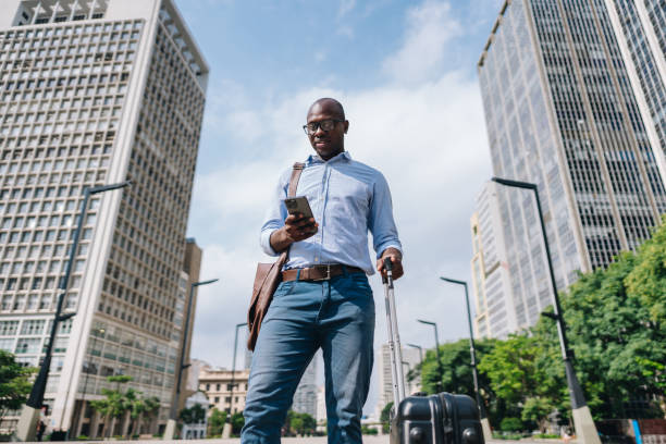 Businessman using the mobile phone in the street