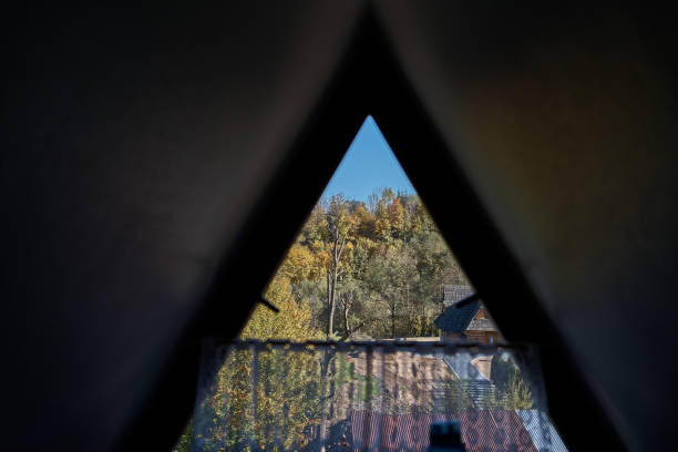 istock View of the autumn forest through a triangular window in the attic 2030051253