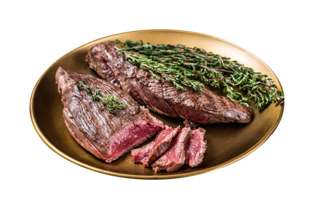 istock BBQ grilled Bavette Bavet beef meat steak with herbs on a plate.  Isolated on white background. 2030080937