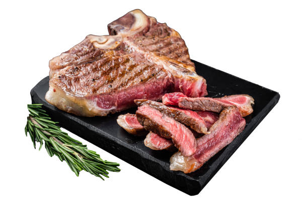 istock T bone grilled beef meat Steak, cooked Porterhouse on a marble board.  Isolated on white background. 2030081521