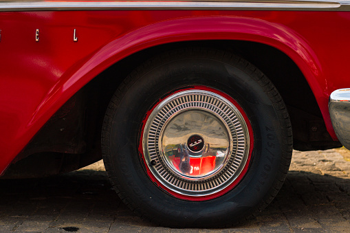 closeup shot of red ford edsel 1958 year edition front wheel , Tbilisi , Georgia