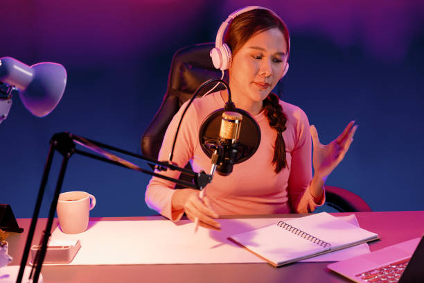 istock Smiling creative young beautiful Asian influencer talking in channel. Stratagem. 2030107105