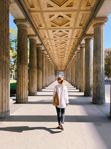 Woman walking through Kolonnadenhof Berlin Mitte summer Germany