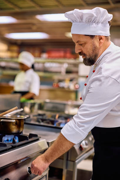 istock Professional chef cooking in the kitchen in a restaurant. 2030120038