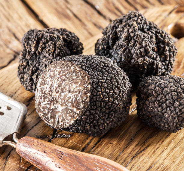 istock Summer truffles and truffle slices isolated on white background. Close-up.. 2030120046