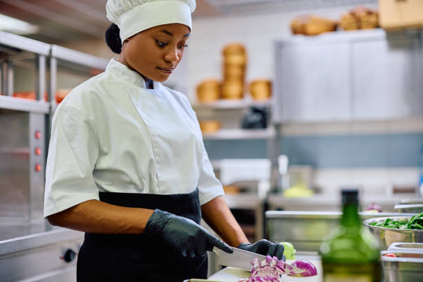 istock Black female chef preparing food while working in the kitchen. 2030120077
