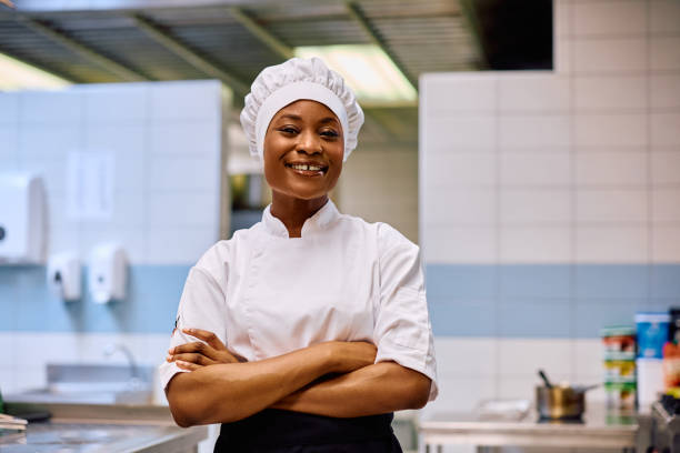 istock Confident black female chef in the kitchen looking at camera. 2030121662