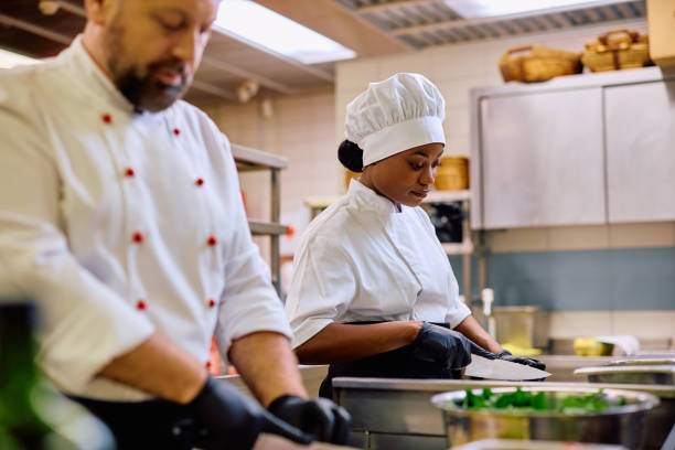 istock Black female chef working int he kitchen in a restaurant. 2030123262
