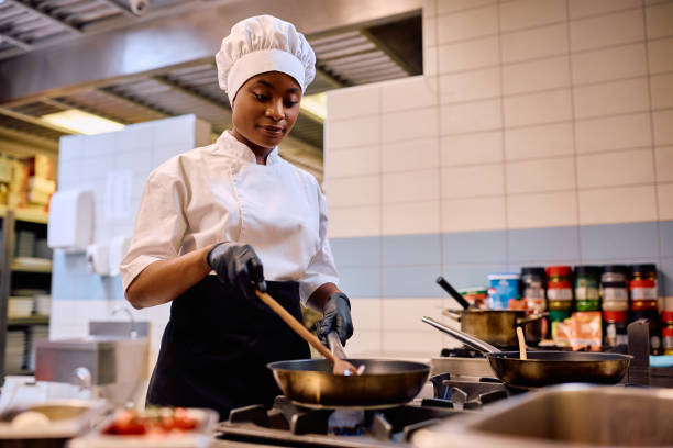 istock Black female chef cooking while working in the kitchen in a restaurant. 2030123280