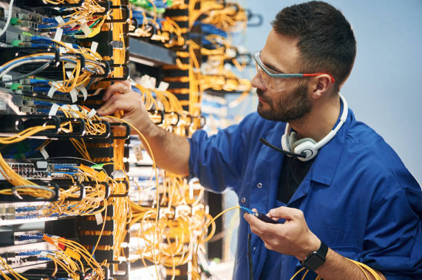 istock Checking signal by device. Young man is working with internet equipment and wires in server room 2030126454