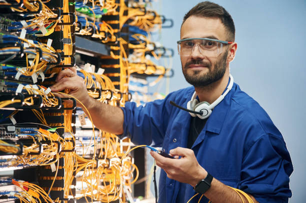 istock Checking signal by device. Young man is working with internet equipment and wires in server room 2030126963