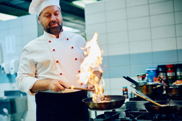 istock Professional cook preparing a dish while working in the kitchen at restaurant. 2030126976