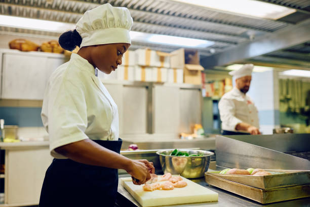 istock Black female cook preparing food while working in a restaurant. 2030127513