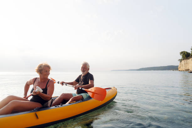 istock Senior couple kayaking at sunset 2030131865