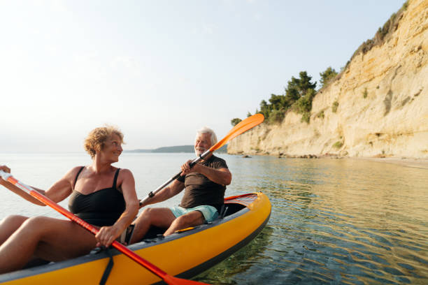 istock Senior couple kayaking at sunset 2030132440