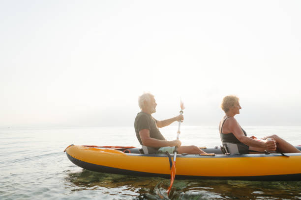 istock Senior couple kayaking at sunset 2030132912