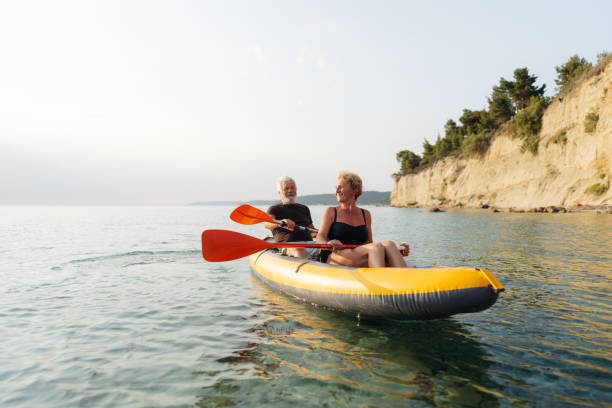 Senior couple kayaking at sunset