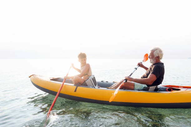 istock Grandfather and grandson kayaking together 2030136543