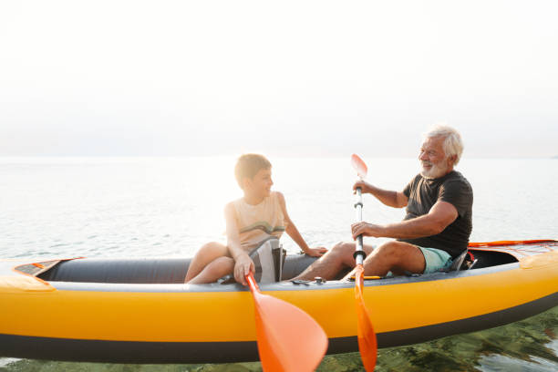 istock Grandfather and grandson kayaking together 2030136554