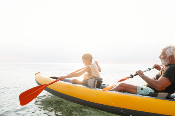 istock Grandfather and grandson kayaking together 2030137088
