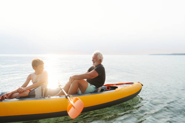 istock Grandfather and grandson kayaking together 2030137098