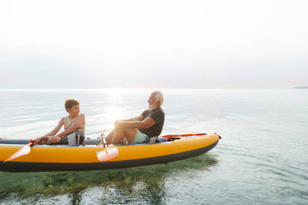istock Grandfather and grandson kayaking together 2030137623