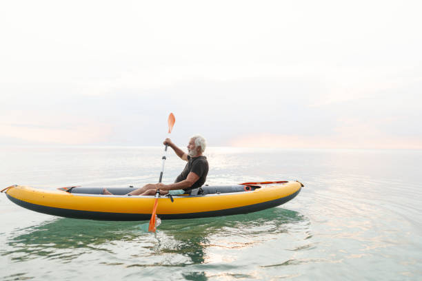 istock Senior man kayaking at sunset 2030139736