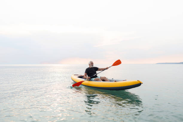 istock Senior man kayaking at sunset 2030140257