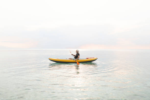 istock Senior man kayaking at sunset 2030141297