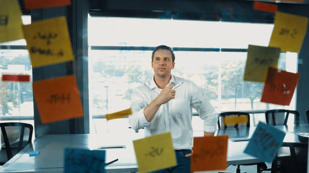 istock Professional businessman analysis marketing idea on sticky notes. Manipulator. 2030143949