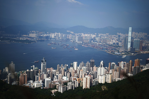 hong kong, Hong Kong – November 06, 2023: A bustling Hong Kong cityscape nestled among towering mountains, filled with numerous buildings