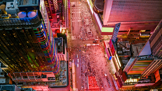 Aerial shot above the busy Times Square in Central Manhattan at night. Shot in New York City, USA.