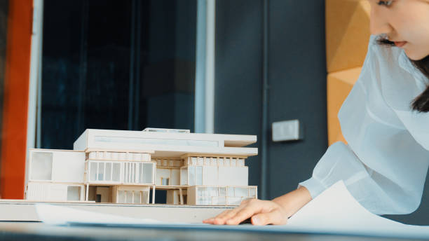 istock Closeup of asian young beautiful engineer looking at project plan. Manipulator. 2030171826