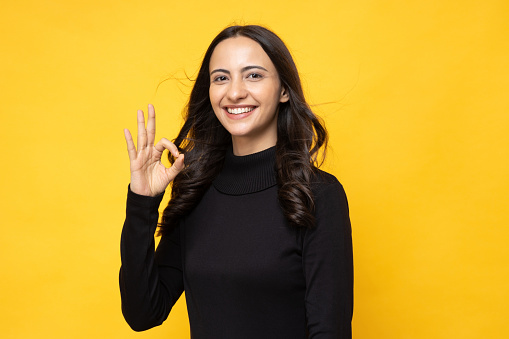 Asian woman happy giving hand make greeting gesture and looking at camera isolated over white background.