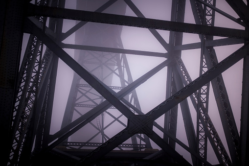 Iron structures of the The Dom Luis I Bridge in thick fog, Porto, Portugal.