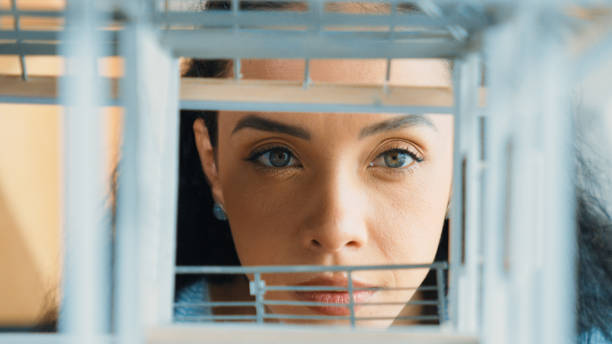 Closeup image of young hispanic architect engineer inspect house model construction. Project manager looking inside building while checking architectural model structure. Focus on face. Manipulator.