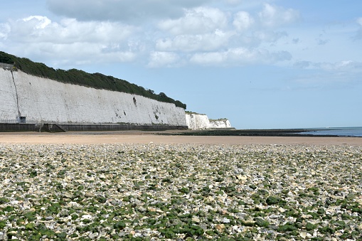 Landscape view of White cliffs at Margate, Kent .  Sun shinning on the white chalky stone cliffs in the daytime in summer